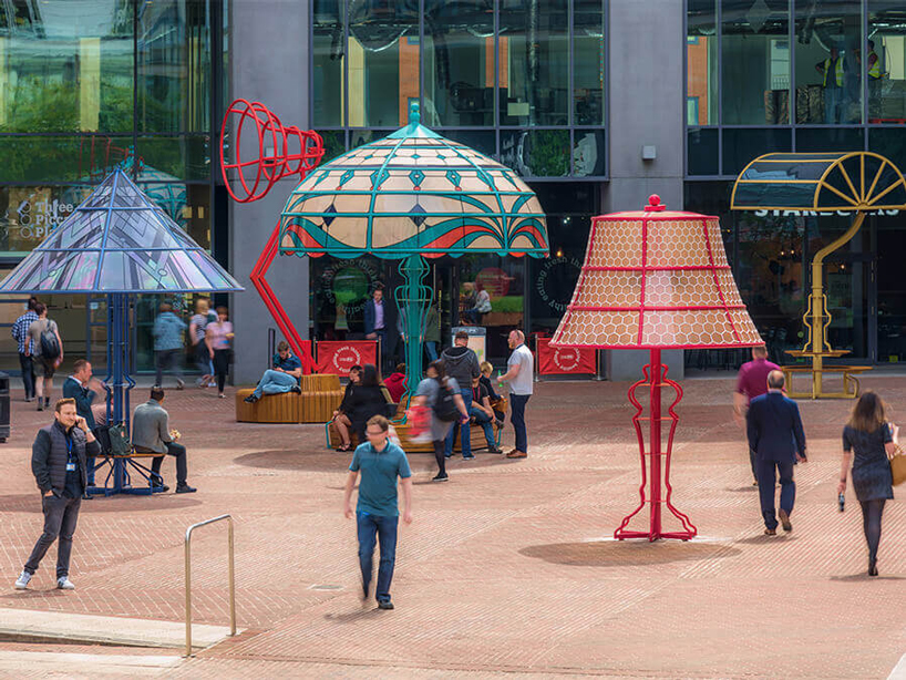 People interacting with supersized lamps in Manchester Square